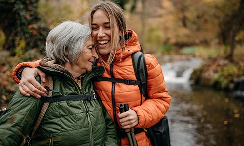 a couple of women smiling while hiking