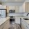 Modern Townhome kitchen with light designer finishes and kitchen island at Cadia River District.