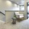 Large upper staircase landing of two-story 3 bedroom townhome in Eagle Idaho furnished with reading chair and side table.