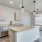 Kitchen with pendant lighting and light cabinetry at Cadia River District Apartments in Eagle, Idaho.